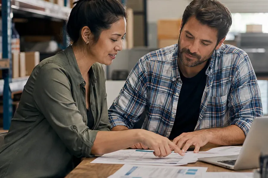 Consultant and owner reviewing an inventory report and cost estimate
