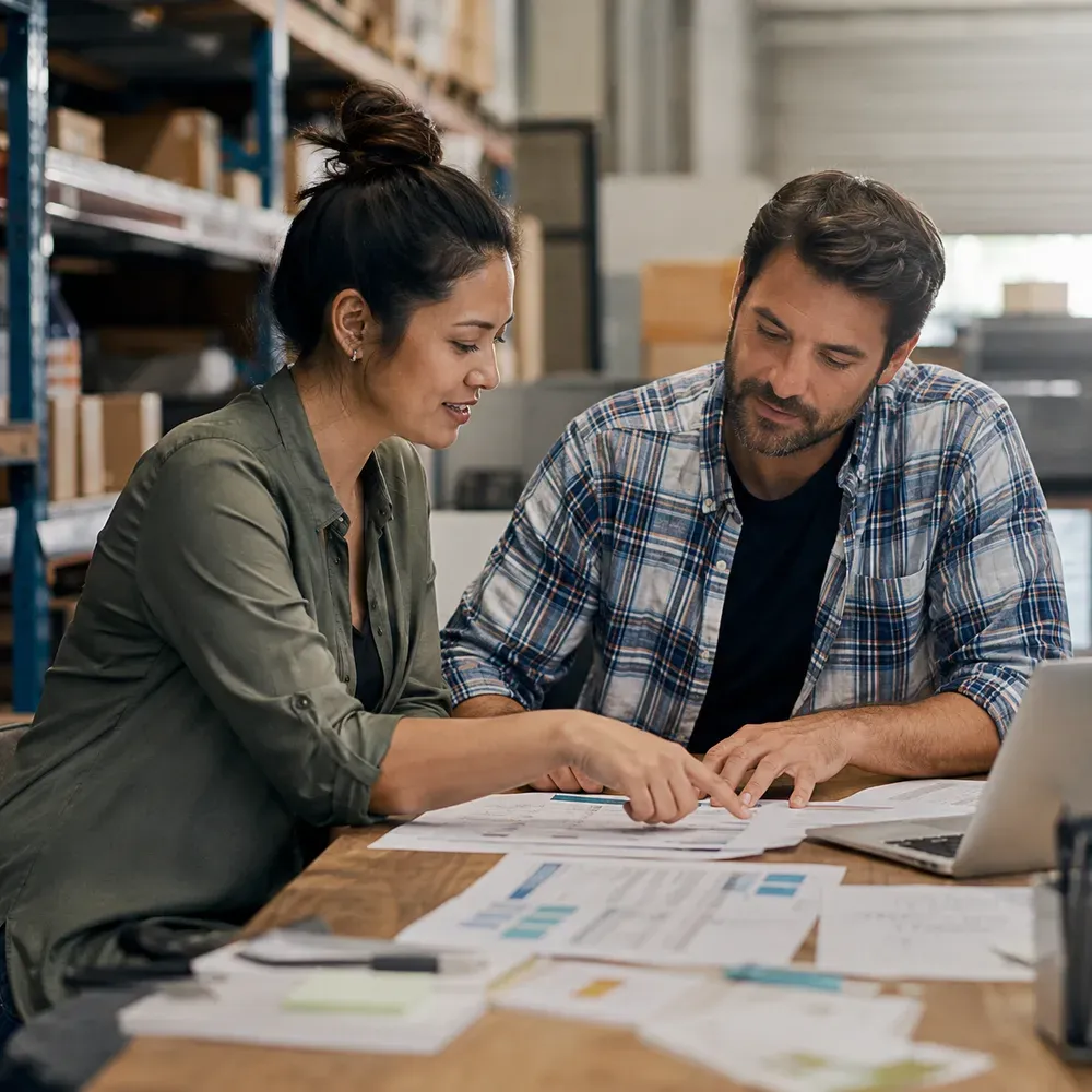 Consultant and business owner reviewing an inventory report and phased plan